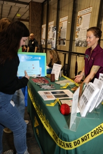 outreach event with people and display table